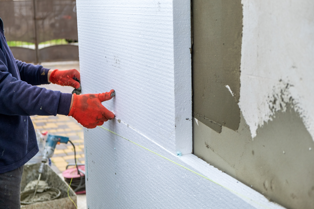Construction,Worker,Installing,Styrofoam,Insulation,Sheets,On,House,Facade,Wall